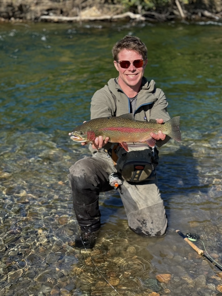 Fly out fisherman holding a fish